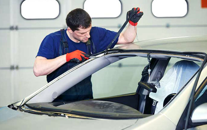 Technician working to repair car windshield