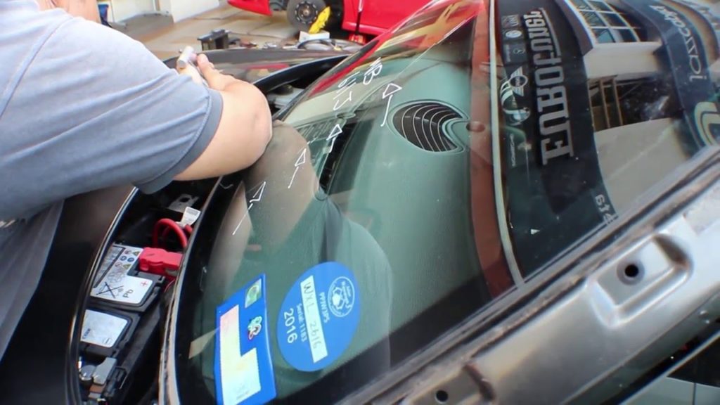 Fixing front windshield on toyota car